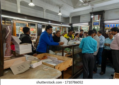 Kolkata, West Bengal, India - 29th December 2019 : Nahoum And Sons, New Market Area Is A Very Famous And Old Cake Shop. Sales People Are Busy Selling Cakes Over The Sales Counter Inside The Shop.