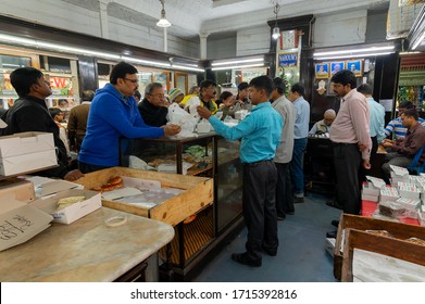 Kolkata, West Bengal, India - 29th December 2019 : Nahoum And Sons, New Market Area Is A Very Famous And Old Cake Shop. Sales People Are Busy Selling Cakes Over The Sales Counter Inside The Shop.