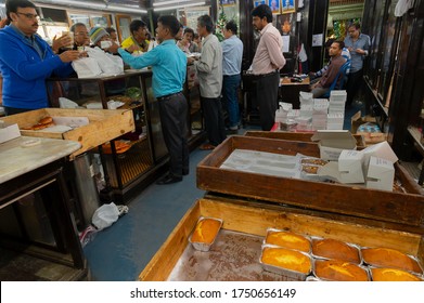 Kolkata, West Bengal, India - 29th December 2019 : Nahoum And Sons, New Market Area Is A Very Famous And Old Cake Shop. Sales People Are Busy Selling Cakes Over The Sales Counter Inside The Shop.