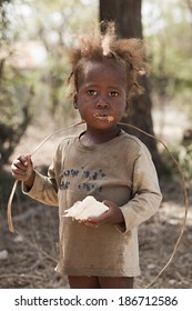 KOLMINY, HAITI - FEBRUARY 12, 2014.  Haitian Toddler Showing Signs Of Malnutrition Eating Peanut Butter Bread Given To Her By Missionaries.