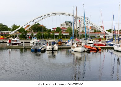 Kolobrzeg, Poland - June 15, 2017: The sailboats are in the marina and the bridge is a bit further away. This modern bridge is called Port Bridge. 