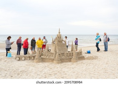   Kolobrzeg, Polen - 06. September 2021: Die Urlauber bewundern ein Sandburg am Strand von Kolobrzeg an der polnischen Ostseeküste                             