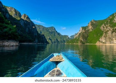 Komani Lake scenery with steep mountains and lush forests in northern Albania.  - Powered by Shutterstock