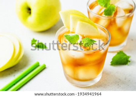 Kombucha cocktail, summer festive party drink, apple iced tea in glasses. Space for text.