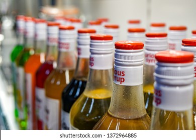 KOMSOMOLSK, RUSSIA - APRIL 18, 2019: a shelf with coffee syrups in a cafe, colored fillers for coffee and cocktails                               