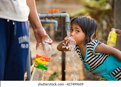 Kon Tum, Vietnam - Mar 29, 2016: A Little Girl Drink Water From Outdoor Tap Which Water Supplied By Drilling Well In Central Highland Of Vietnam. Fresh Water Is Problem In Underdevelopment Region