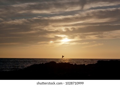 Kona Sunset Hawaii With Crab Claw Sailboat Passing In Front; Big Island