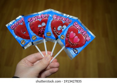 Kongsvinger, Norway 9 February 2021: Caretos Fini Funny Faces Sign On Red Heart Shaped Lollies Candy Bars Wrapped Weird Faces Sweets Love Lollipop Sticks