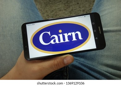 KONSKIE, POLAND - April 13, 2019: Man Holding Smartphone With Cairn Energy PLC Logo