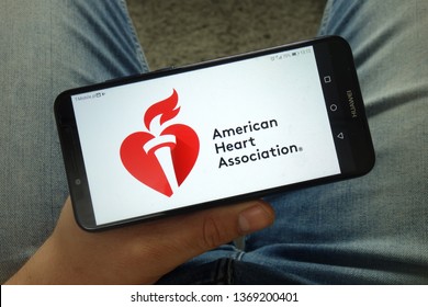 KONSKIE, POLAND - April 13, 2019: Man Holding Smartphone With American Heart Association (AHA) Logo