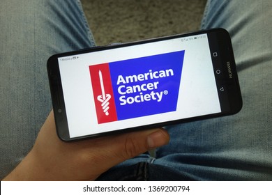 KONSKIE, POLAND - April 13, 2019: Man Holding Smartphone With American Cancer Society (ACS) Logo