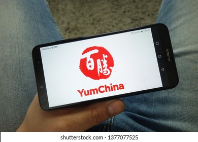 KONSKIE, POLAND - April 13, 2019: Man Holding Smartphone With Yum China Restaurant Company Logo