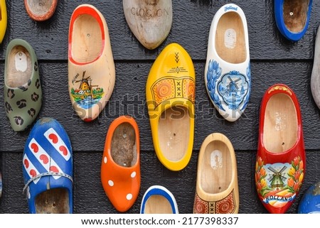 Koog aan de Zaan, Netherlands. July 2022. Colorful clogs against the background of a wooden wall. Popular souvenirs. Traditions of Holland. High quality photo. Close up. Selective focus.