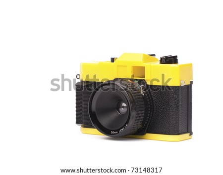 Kooky little plastic camera on white. lots of room for type.