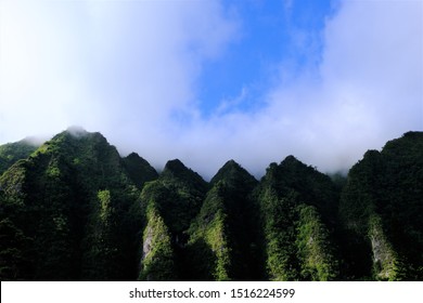 Ko'olau Mountain range along the windward side of Oahu, Hawaii.  Shots of the tops of several different ridges against blue sky, cloud sky and with clouds settled on top of the ridges.