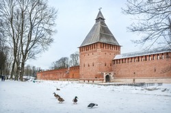 Kopytenskaya Tower With Gates And Ducks In The Snow In Smolensk Under A Spring Snowy Sky
