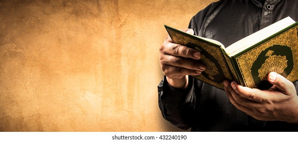 Koran in hand - holy book of Muslims ( public item of all muslims )