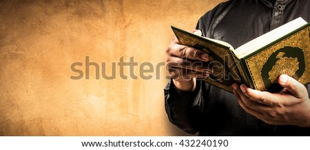 Koran in hand - holy book of Muslims ( public item of all muslims )