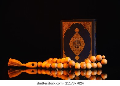 Koran And Muslim Prayer Beads On Dark Background