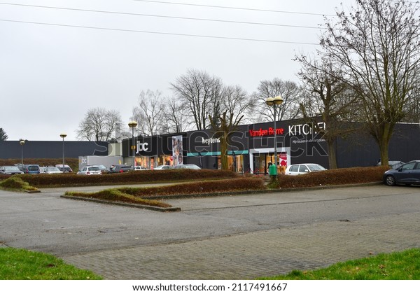 Korbeek-Lo, Vlaams-Brabant, Belgium - February 2, 2021:\
Shopping district apparel C and A , electro Vanden  Borre Kitchens,\
Heytens home stuff and JBC clothing. Lot of in suburb parking\
space. 