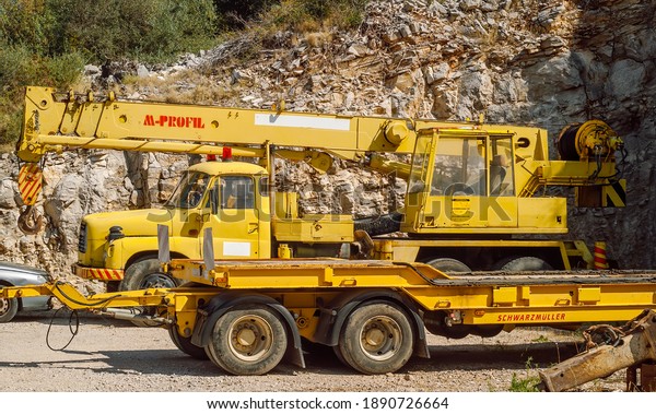 Korcula, Croatia- Sep 1, 2020\
Old engineering\
vehicle, yellow construction machines, TATRA truck crane and\
platform trailer.