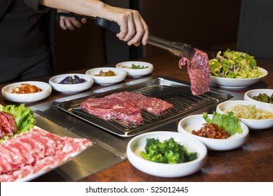 Korean BBQ Raw Beef on the Grill and Pickled Banchan Vegetables