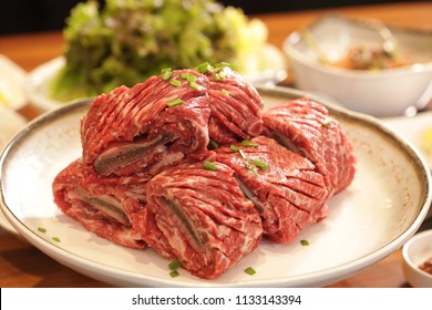 Korean beef, called 'ribs', is placed on a plate with various side dishes.
