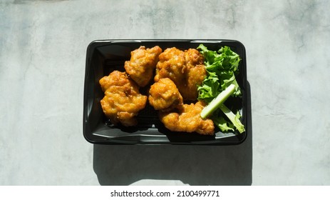 Korean Cheap Fried Chicken Sold On A Black Plastic Plate.