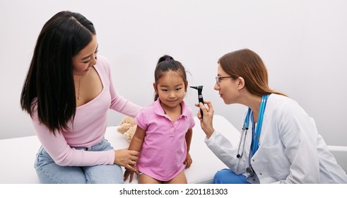 Korean Child With Her Mother During Hearing Test, Audiologist With Otoscope Checking Ear Of Asian Little Girl. Hearing Exam