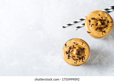 Korean Dalgona Coffee With Brown Foam In Glass Close Up On White Background, Copy Space, Top View, Flat Lay