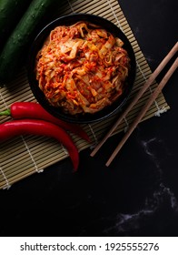 Korean food, Cabbage kimchi in black dish set on dark background.