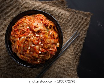 Korean food, Cabbage kimchi in black dish set on dark background.
