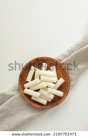 Korean food ingredient, dried rice cake Tteok on wooden plate