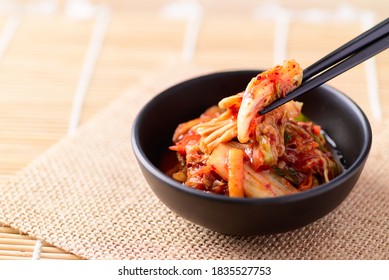 Korean Food, Kimchi Cabbage In A Bowl Eating With Chopsticks