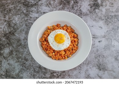 Korean Food Kimchi Fried Rice Dish With Fried Egg On White Plate