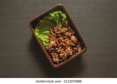 korean fried beef with spicy korean sauce (bulgogi), with sesame seeds toppings, chopped onions, and fresh vegetables. - Shutterstock ID 2113595888