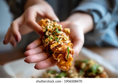 Korean Fried Chicken Tender With Hands Holding