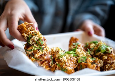 Korean Fried Chicken Tender With Hands Holding