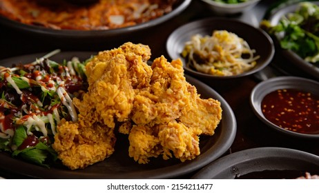 Korean Grilled BBQ Combo Sets With Fried Chicken On The Traditional Grill Table, And Pickle Dishes