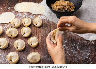 Korean handmade dumplings. Knead the flour by hand to make dumplings. - Shutterstock ID 2253315043