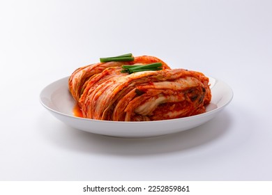 Korean kimchi. Korean traditional cabbage kimchi on white plate. White background, frontal closeup. - Shutterstock ID 2252859861
