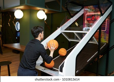 Korean Man Playing Basketball Arcade Game 