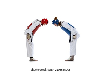 Korean martial arts. Studio shot of two young women, taekwondo athletes greeting each other isolated over dark background. Challenges. Concept of sport, education, skills, workout, health - Powered by Shutterstock