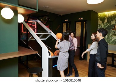 Korean Men And Women Playing Basketball Arcade Game 