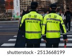 Korean police squad formation in protective uniform with "Police" logo, policemen patrol maintain public during political demonstration protest rally in the streets of Seoul city center, South Korea 