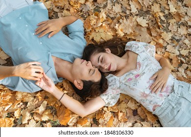 Korean Spanish Couple At The Park Sleeping On A Bed Of Leafs In Autumn