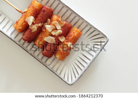 Korean street food, sausage and rice cake with spicy sauce So-tteok
