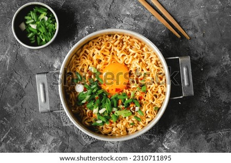 Korean Style Instant Noodles, Shin Ramyeon or Ramyun with Egg, Scallion and Broth, Noodle Soup on Dark Background