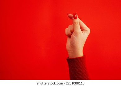 The Korean symbol for love is obvious. A woman's hand covers a heart. Place for text. Happy Valentine's day