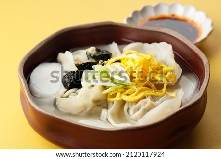 Korean Traditional Food Sliced Rice Cake Soup, Tteok and Mandu Dumpling Soup, Close Up